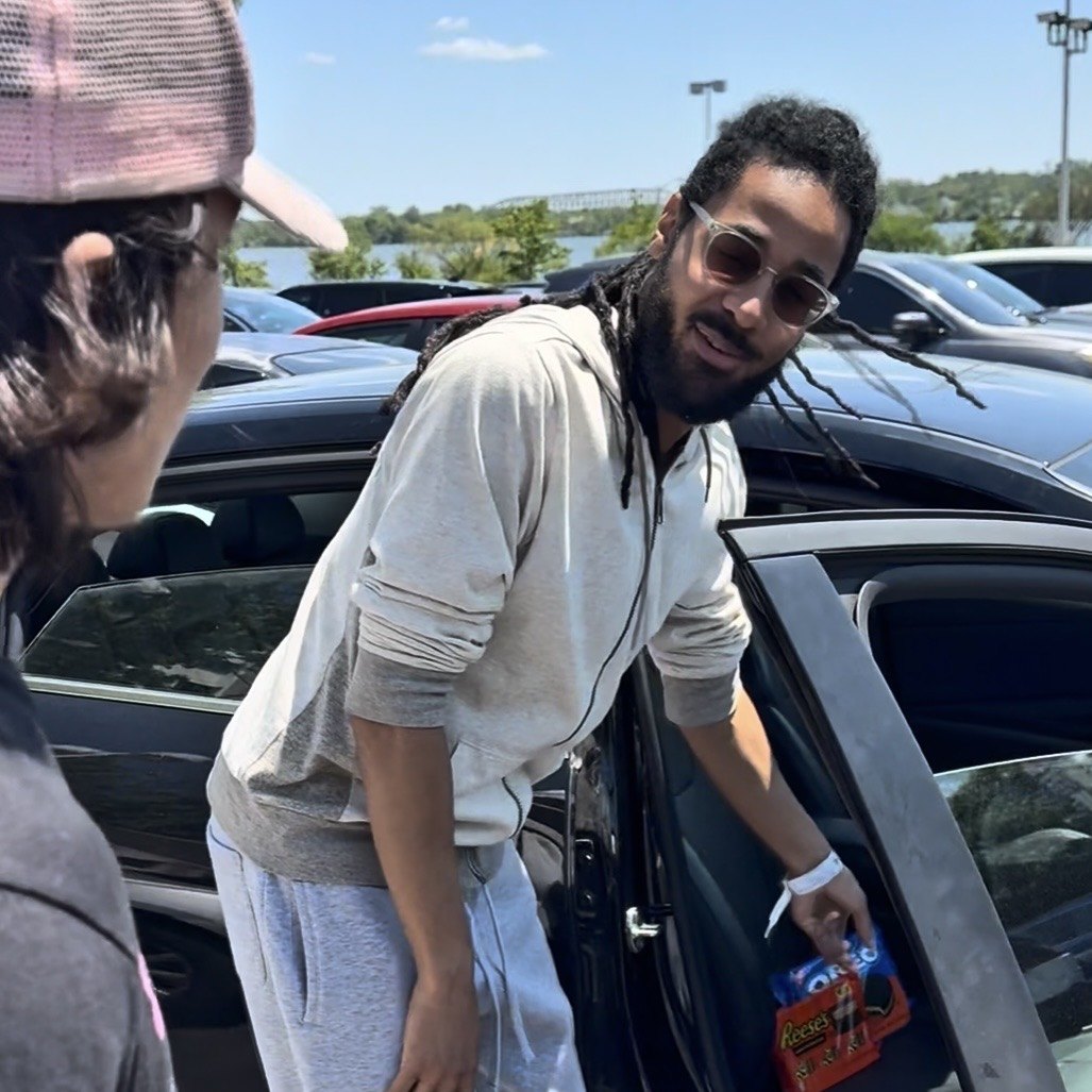 Clean AF detailer hand-washing a vehicle outside